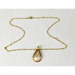 An 18ct gold pendant set with a teardrop-shaped pearl, and tiny diamonds,