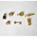 Seven 9ct yellow and rose gold bracelet charms, comprising a pig,