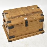 A rustic metal bound casket with hinged lid and pair of wooden carry handles,