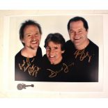 THE MONKEES; a colour photograph bearing the signatures of Peter Tork, Davy Jones and Mickey Dolenz,