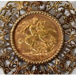 A 1979 full sovereign in a 9ct gold pierced foliate mount, approx 16g.