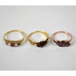 A 9ct yellow gold ladies' dress ring set with three deep pink stones, size J, approx 1.