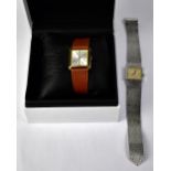 ENKA; a stainless steel wristwatch, the square dial set with baton numerals,