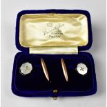 A pair of 1930s 9ct gold cufflinks with hexagonal head with gold knot on a pearlescent background,