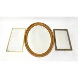 Three wall mirrors comprising a gilt-framed oval example with bevelled plate and two rectangular