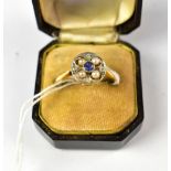 An Art Deco 18ct gold ring, the circular top with central bezel set sapphire,