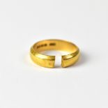 A 22ct gold wedding band, stamped '22', approx 4g (af, cut).