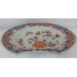 An 18th/19th century Japanese porcelain barber's bowl in Imari palette of iron red floral pattern