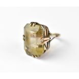 A 9ct rose gold smoky quartz dress ring, the emerald cut stone in claw mount, size J, approx 6.8g.