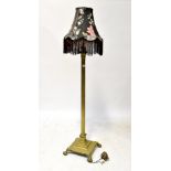 An early 20th century brass standard lamp with fluted central column to square section base and