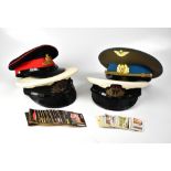 Four military peaked caps to include two Royal Navy examples,