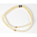 BOODLE & DUNTHORNE; a double-strand well matched pearl necklace,