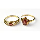 Two 9ct gold dress rings, each with a single red stone, sizes O and P, combined approx 3.7g (2).