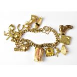 A 9ct gold curb link charm bracelet set with twelve charms including a ten shilling note,