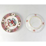 A pair of Chinese Famille Rose plates, each painted with peonies within lattice and floral borders,