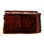 An Afghan hand knotted carpet pillow with beaded fringe, 109 x 64cm.