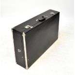 A refurbished vintage black leatherette and metal bound car trunk,