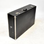 A refurbished vintage black leatherette and metal bound car trunk,