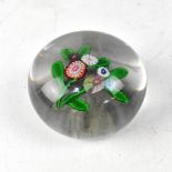 A 19th century glass paperweight with simple floral spray, diameter approx 7.5cm.