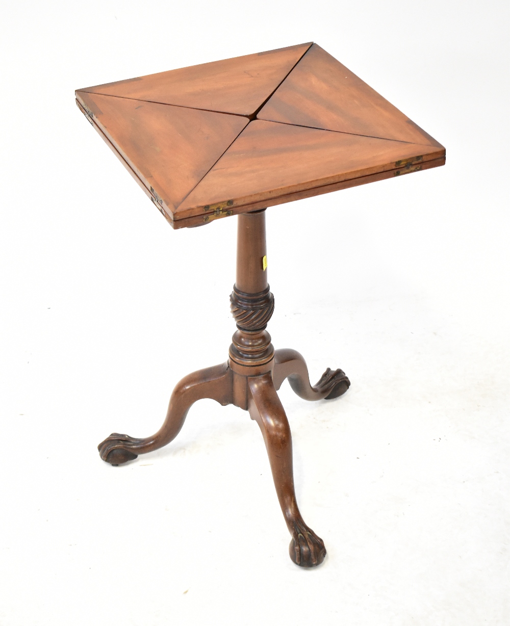 A Victorian mahogany envelope table raised on turned pedestal with three cabriole legs,