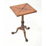 A Victorian mahogany envelope table raised on turned pedestal with three cabriole legs,
