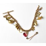 A 9ct gold curb link charm bracelet with fourteen charms including a T-bar, with lobster clasp,