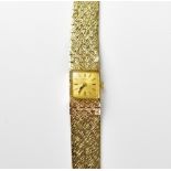 TUDOR; a 9ct gold wristwatch, the square dial set with baton numerals,