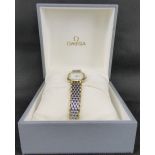 OMEGA; a ladies' De Ville wristwatch, with gold plated and steel bracelet,