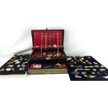 A concertina-style jewellery box and contents and three trays of costume jewellery brooches and