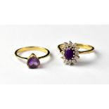 A 9ct gold dress ring with an oval purple stone within a border of white stones, size Q, approx 3.