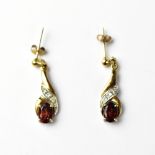 A a pair of yellow metal earrings set with diamonds and garnets, unmarked,