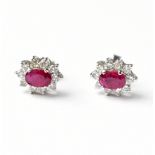 A pair of 18ct white gold ruby and diamond oval cluster ear studs, length approx 11mm,