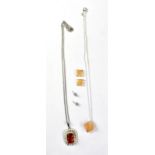 A sterling silver necklace with large amber coloured insert and a sterling silver necklace and