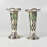 WILLIAM AITKEN; a pair of loaded Edward VII pierced spill vases with green glass liners,