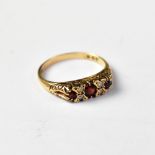 A late 19th/early 20th century 9ct gold garnet and white stone ring,