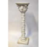 A large plaster column/plant stand, with square top above lion mask with brackets and floral fill,