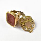 A Victorian yellow metal seal with intaglio armorial crest and banner, in a typical Victorian mount,