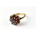 A 9ct gold garnet flower cluster ring, size O, approx 2.5g.