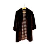 A three-quarter length faux beaver fur coat, with blue and brown check lining, length approx 103cm,