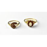 Two 9ct gold vintage-style red stone dress rings, one with a central oval white opal,