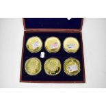Six gold plated commemorative medallions for British banknotes, in a presentation case.