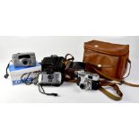 A collection of cameras to include a Canon Sureshot Sleek point-and-shoot film camera,