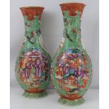 A pair of 19th century Chinese porcelain vases of squat baluster form decorated with an iron red