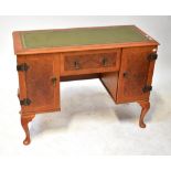 DYNOTRON; a yew wood and burr walnut radiogram cabinet styled as a kneehole desk,