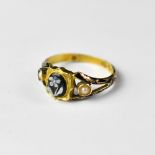 A 19th century 18ct gold mourning ring, the central circular floral cameo in shaped shield mount,