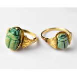 Two yellow metal Art Deco style Egyptian inspired yellow metal rings,