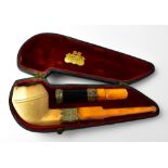 A cased Victorian silver mounted pipe and cigar cheroot with amber stems,