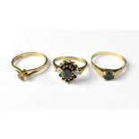 Three 9ct gold dress rings comprising a single green stone example, size R,