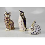 ROYAL CROWN DERBY; three paperweights 'Penguin', 'Cat' and 'Rabbit', one silver stopper,