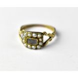 A Victorian 9ct gold mourning ring with small window surrounded by seed pearls,